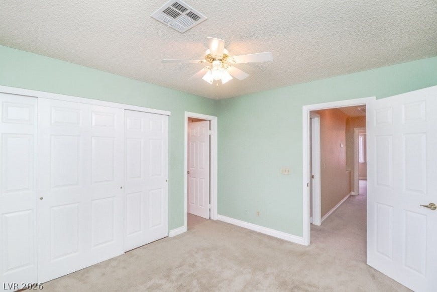 1429 Hawkwood Road, Henderson, NV 89014 Plush carpeted flooring and multiple closets define this bedroom space.