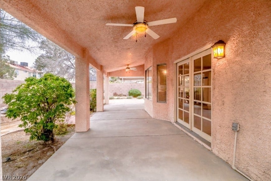 1429 Hawkwood Road, Henderson, NV 89014 Sheltered concrete walkways wind beneath stucco overhangs, presenting ideal spots for quiet afternoon relaxation.