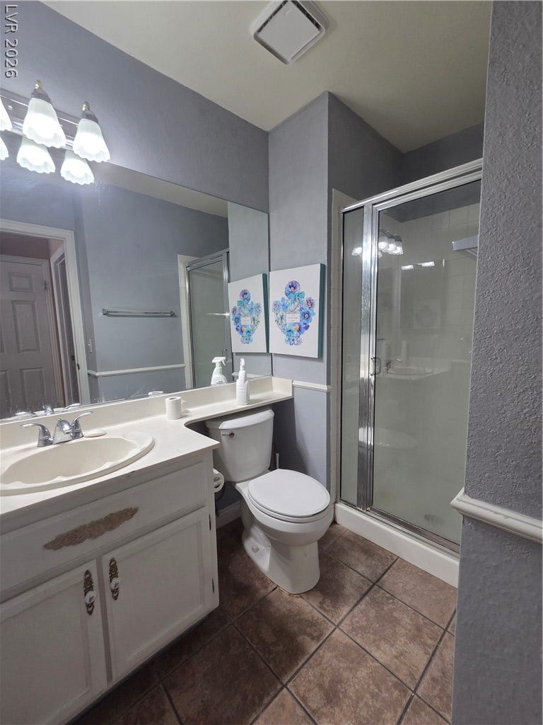 1429 Hawkwood Road, Henderson, NV 89014 Tiled flooring and a glass-enclosed shower stall complete this functional bathroom space.