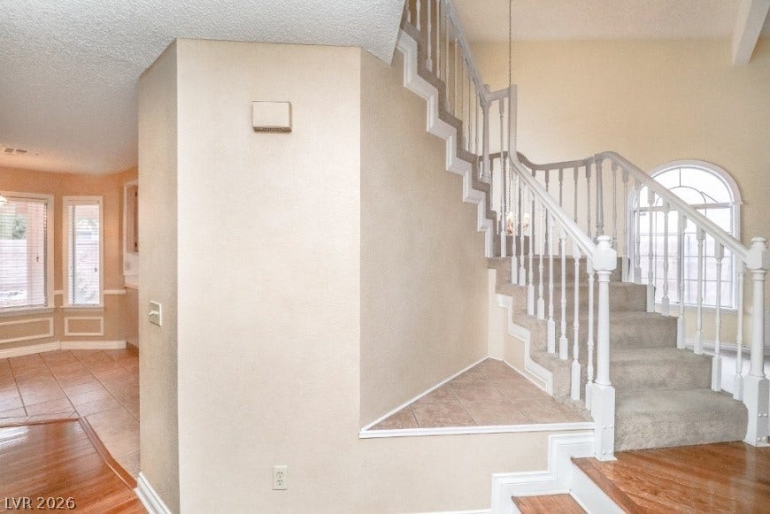 1429 Hawkwood Road, Henderson, NV 89014 An elegant staircase features classic wood balusters and custom detailed trim.