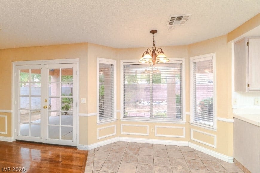 1429 Hawkwood Road, Henderson, NV 89014 Multi-pane glass doors and a bay window illuminate this versatile dining area.