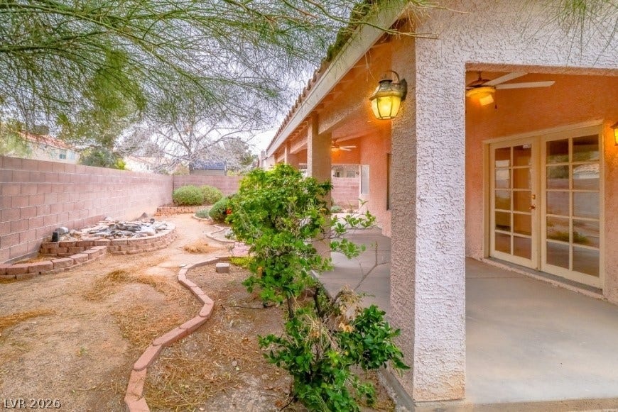 1429 Hawkwood Road, Henderson, NV 89014 A spacious covered patio overlooks the enclosed backyard featuring brick-bordered garden beds.