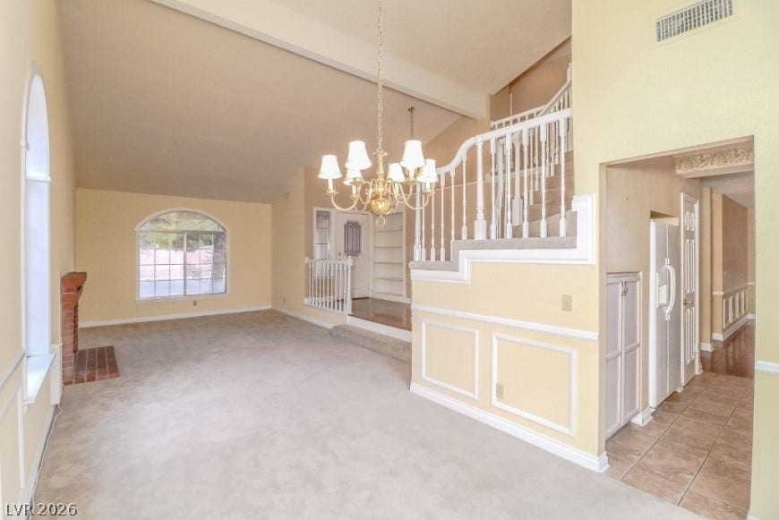 1429 Hawkwood Road, Henderson, NV 89014 Soaring vaulted ceilings and a brick fireplace create a welcoming focal point in this living area.