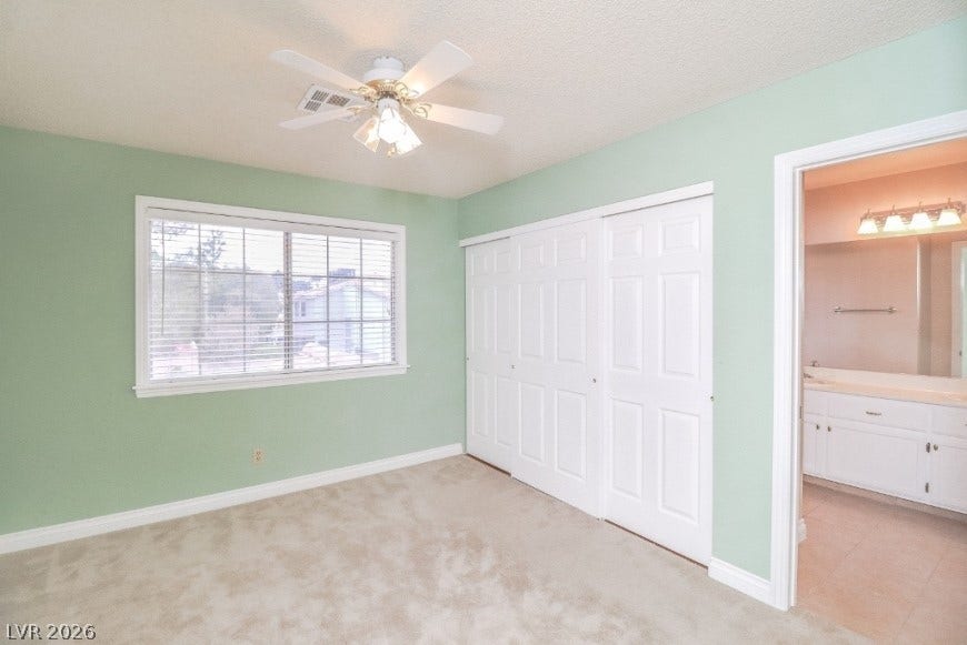 1429 Hawkwood Road, Henderson, NV 89014 Plush carpeting and generous closet space define this comfortable bedroom with an attached bathroom.