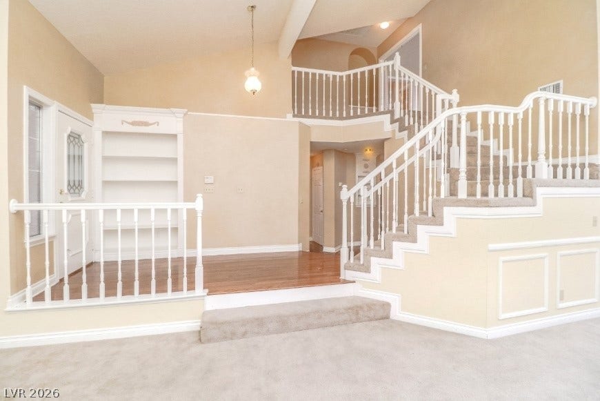 1429 Hawkwood Road, Henderson, NV 89014 Soaring vaulted ceilings and a dramatic multi-level staircase anchor this classic formal entryway.