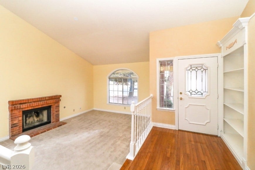 1429 Hawkwood Road, Henderson, NV 89014 An inviting entryway opens directly to a comfortable living area anchored by a brick fireplace.