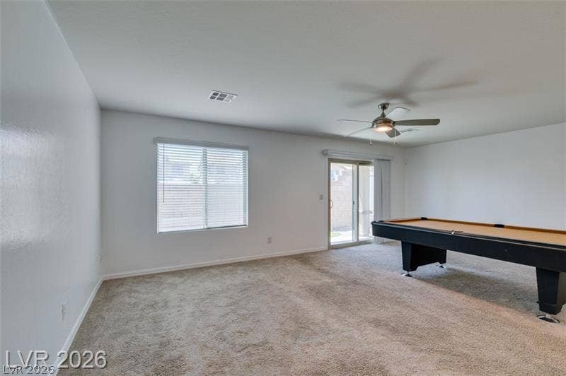 Sliding glass doors open directly to the backyard from this versatile recreation room.