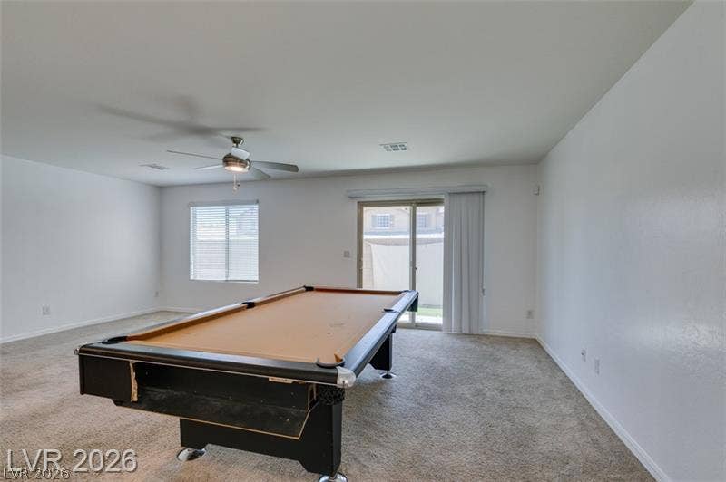 Plush carpeting and sliding glass doors define this versatile recreation space.
