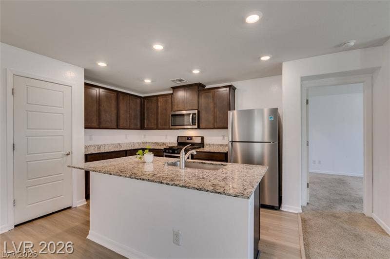 Granite countertops and rich wood cabinetry anchor a modern workspace complete with a center island.