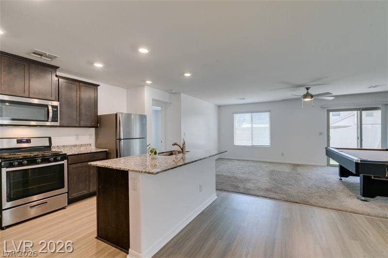 An open floorplan seamlessly connects the functional kitchen space to the adjoining living areas.