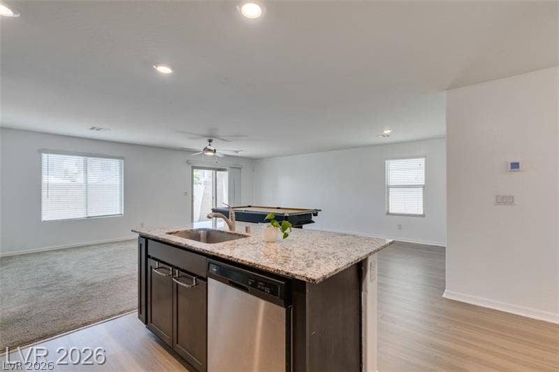 An open floorplan seamlessly connects the kitchen and casual living spaces.