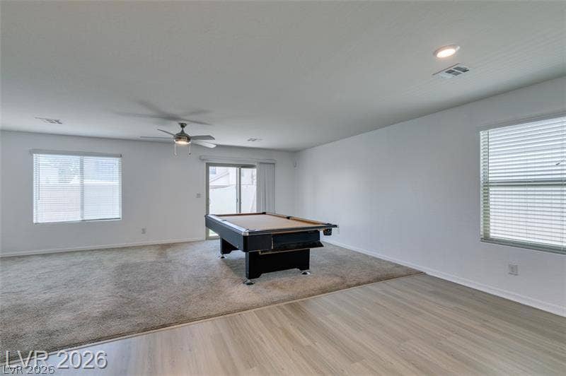 An open and flexible layout features dual flooring options and sliding doors to the backyard.