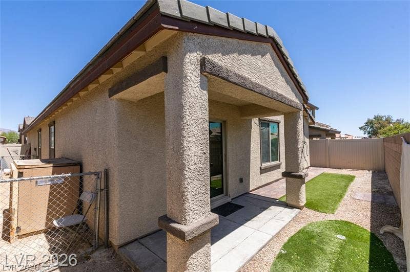 A covered back porch overlooks the low-maintenance yard enclosed by privacy fencing.