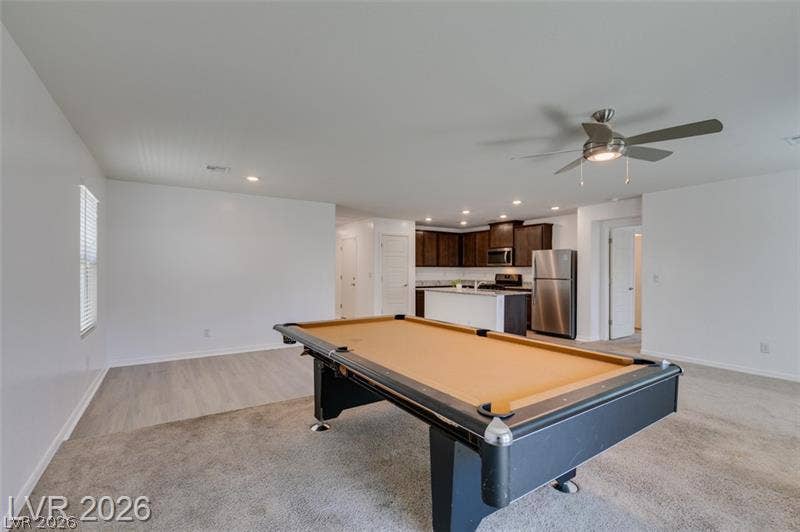 An open layout connects the versatile recreation space directly to the kitchen.
