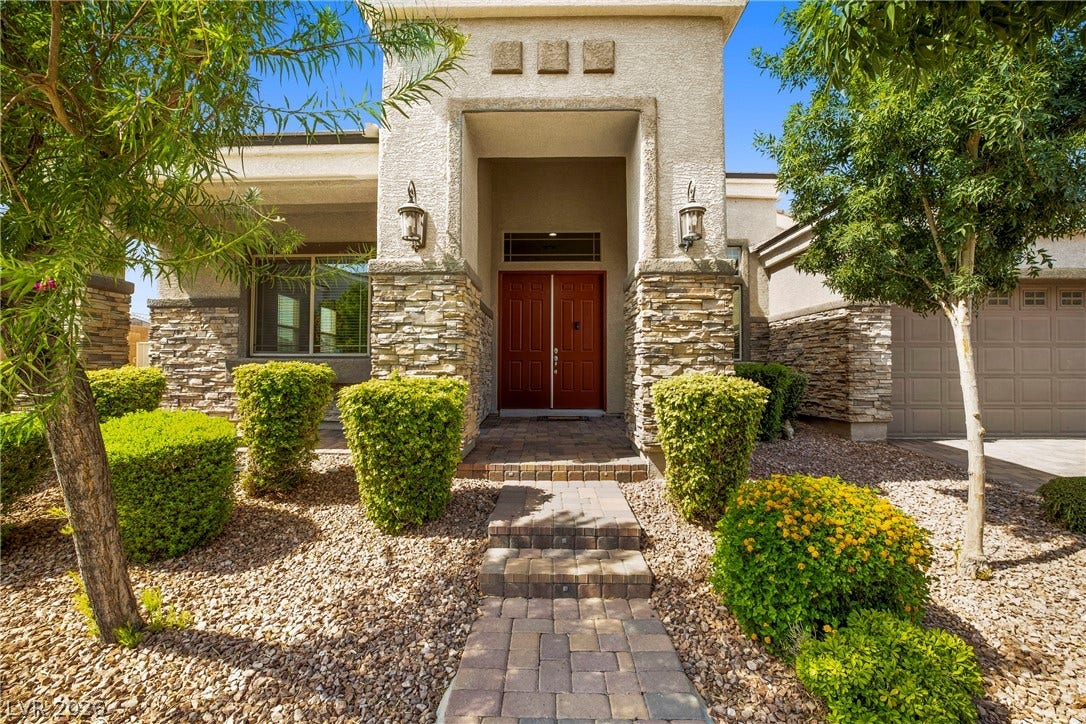 7230 Fresh Harvest Avenue, Las Vegas, NV 89131 A welcoming paver walkway leads to the double entry doors of this home, framed by beautiful stone accents.