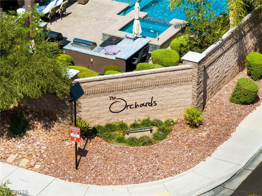7230 Fresh Harvest Avenue, Las Vegas, NV 89131 Welcome home to this inviting community entrance, featuring lush landscaping.