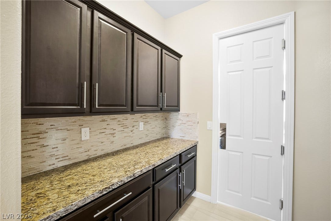 7230 Fresh Harvest Avenue, Las Vegas, NV 89131 Added butlers pantry granite counters and additional cabinets provide added storage, food preparation and convenience between the kitchen and formal dining room.