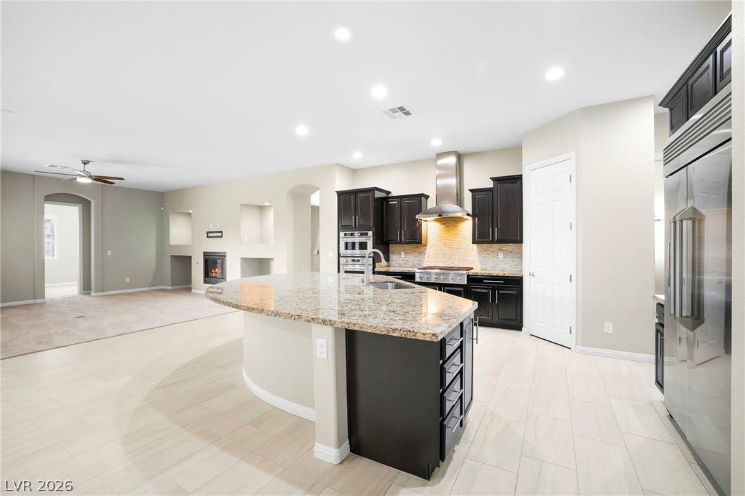7230 Fresh Harvest Avenue, Las Vegas, NV 89131 A gourmet kitchen boasts granite counters and Monogram Appliances.