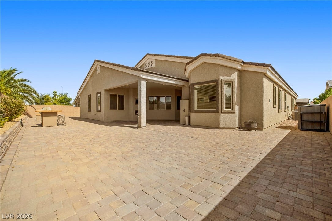 7230 Fresh Harvest Avenue, Las Vegas, NV 89131 A spacious paver patio provides ample outdoor living space behind this inviting residence.