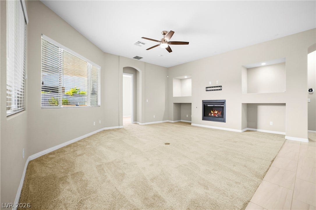 7230 Fresh Harvest Avenue, Las Vegas, NV 89131 An inviting family room provides a cozy fireplace and abundant natural light.