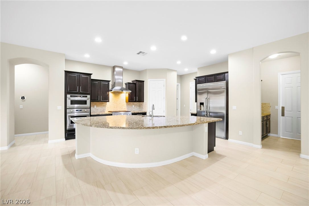 7230 Fresh Harvest Avenue, Las Vegas, NV 89131 Modern kitchen, boasting Monogram Appliances that include a built-in Fridge/Freezer.
