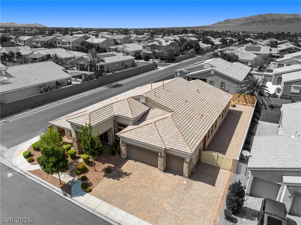 7230 Fresh Harvest Avenue, Las Vegas, NV 89131 An aerial view of the property with it's spacious 12' RV gate & 74' RV parking with 50AMP hook-up, hose bib and sewer clean out.