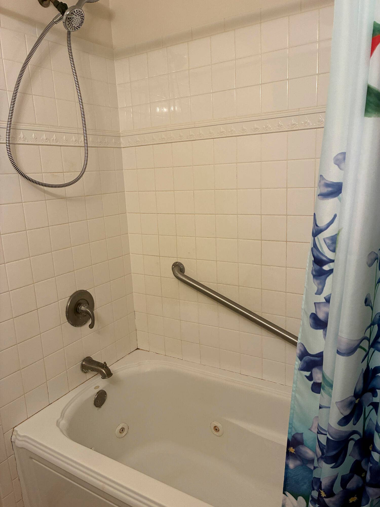 Jetted tub in hall bath with tile surrou
