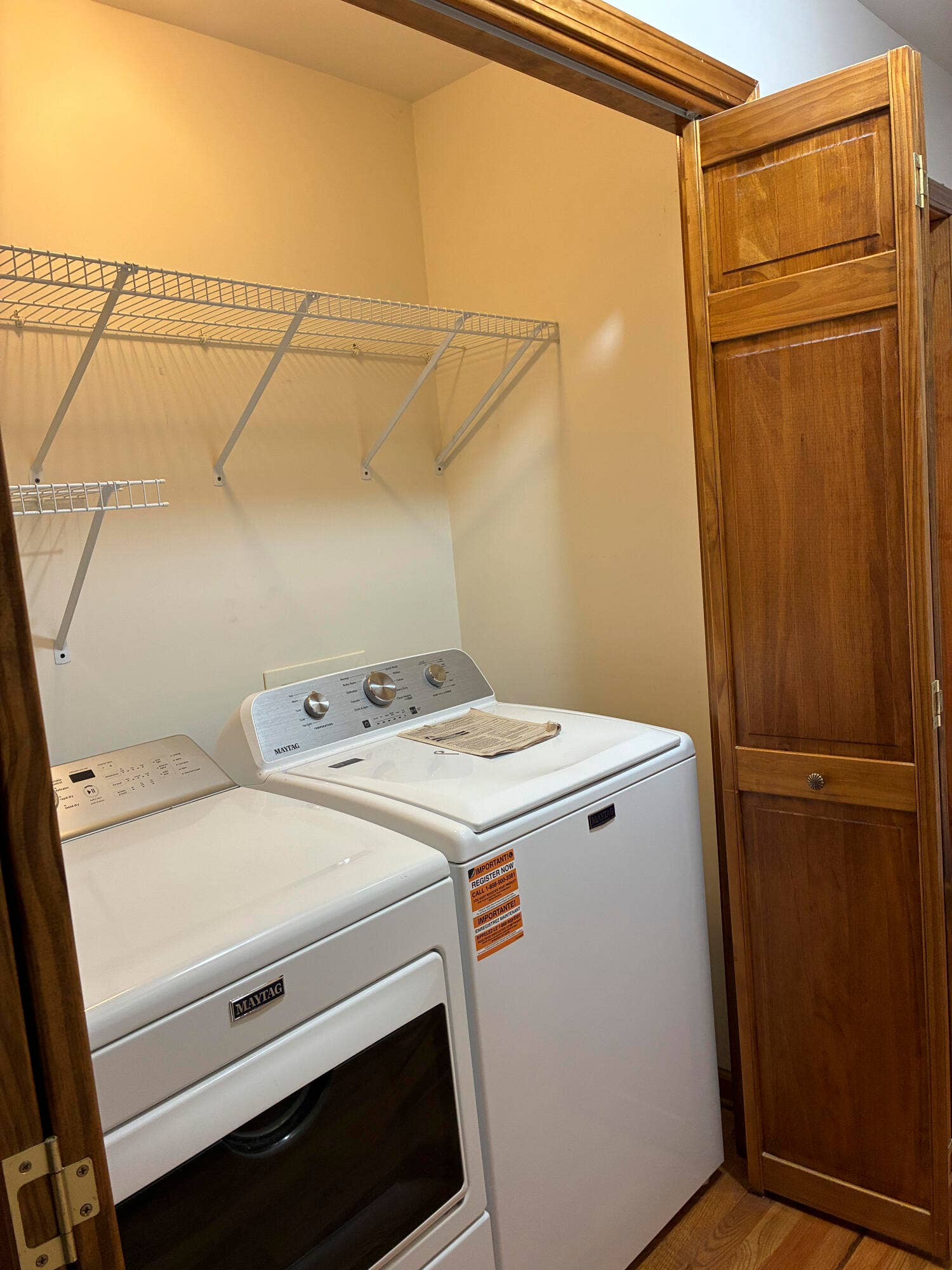 Hall laundry closet with Maytag washer &