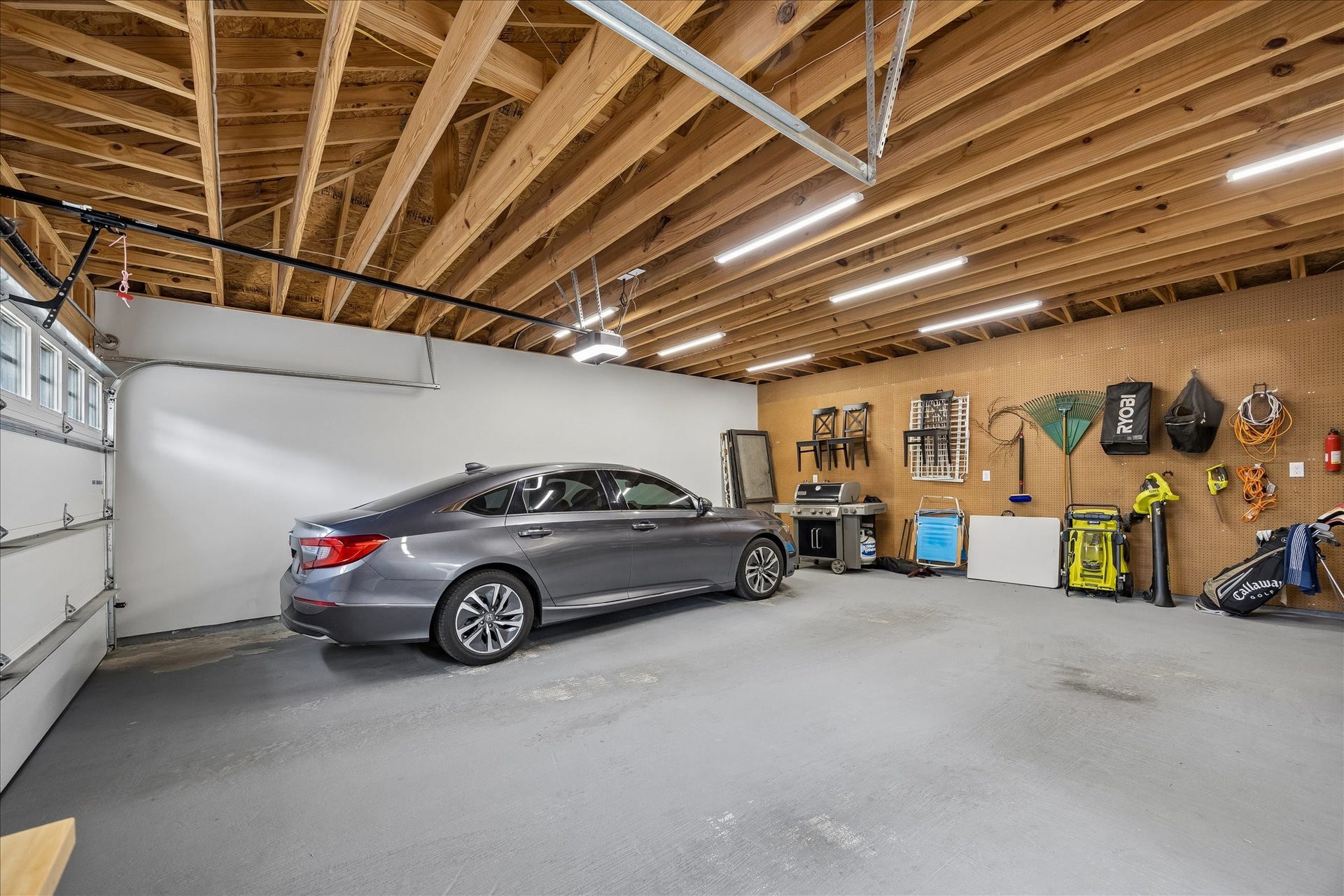 1221 Columbia Street, Houston, TX 77008 The well lit garage is pristine and deep, there is plenty of room for two full size vehicles as well as outdoor and lawn equipment.
