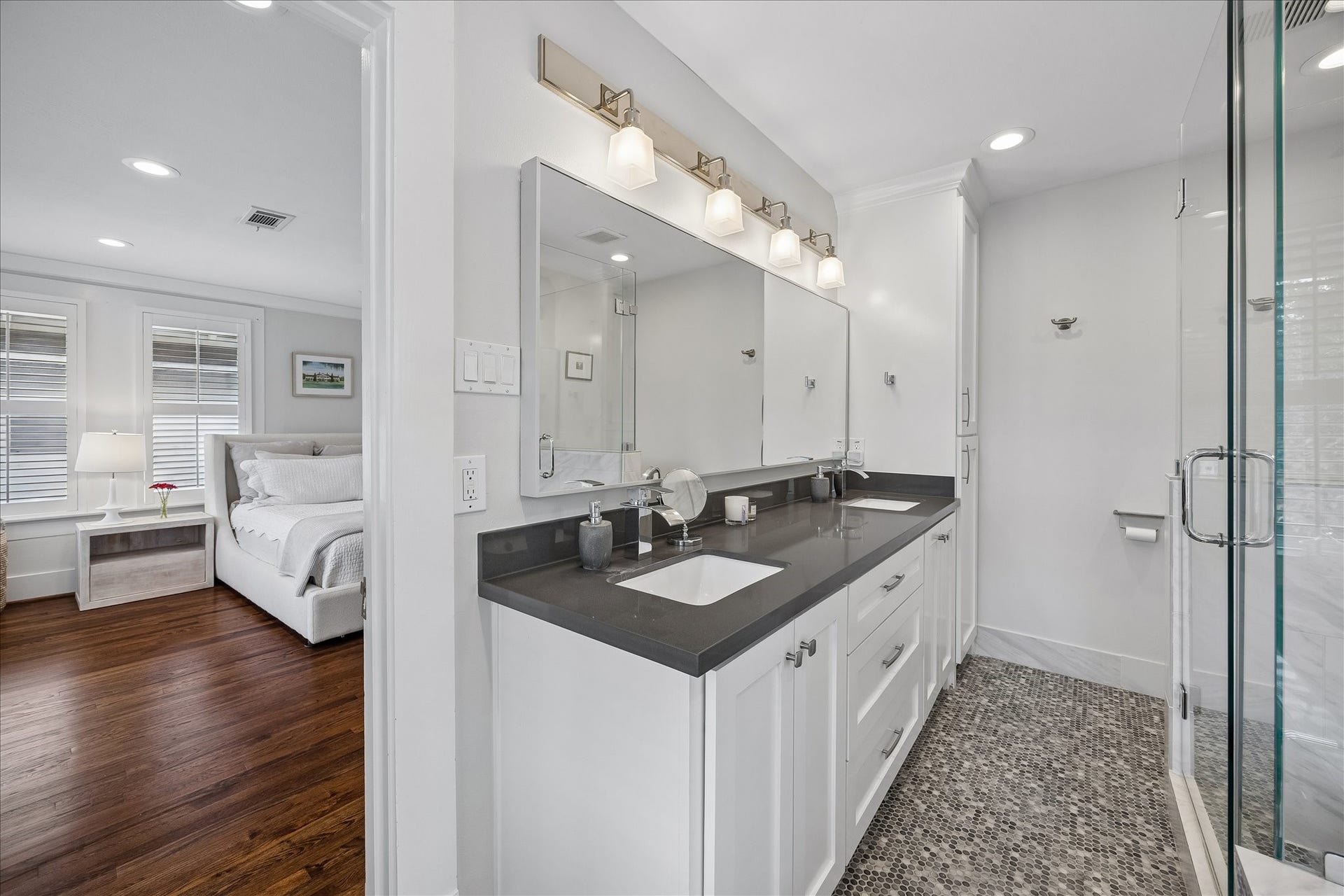 1221 Columbia Street, Houston, TX 77008 A dual sink vanity has excellent lighting, as well as fantastic drawer and cabinet space, including the floor to ceiling linen cabinets at the far end.