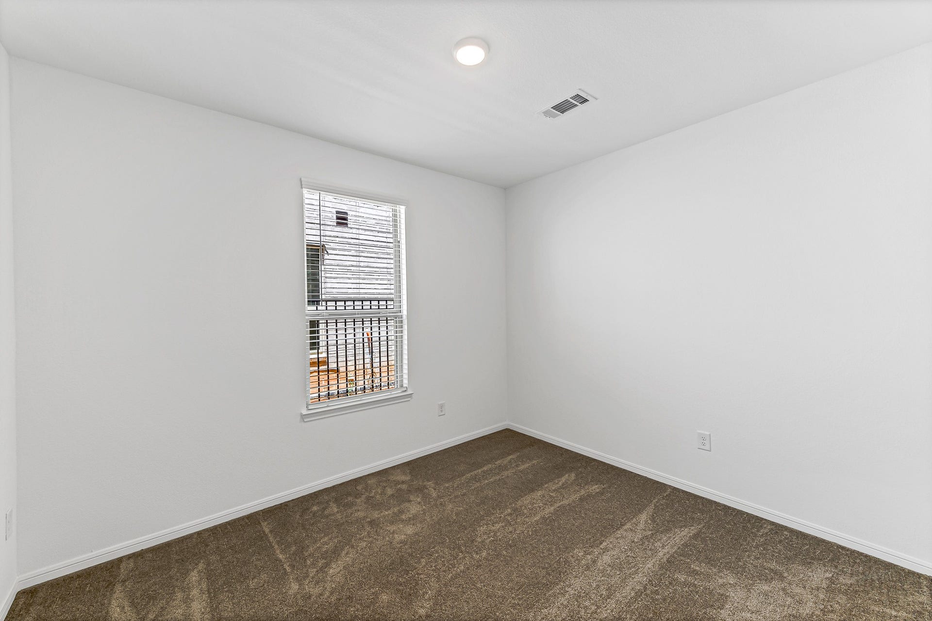 Versatile secondary bedroom at first floor, with direct access to full bathroom. Excellent as in-law suite, home office or guest room.