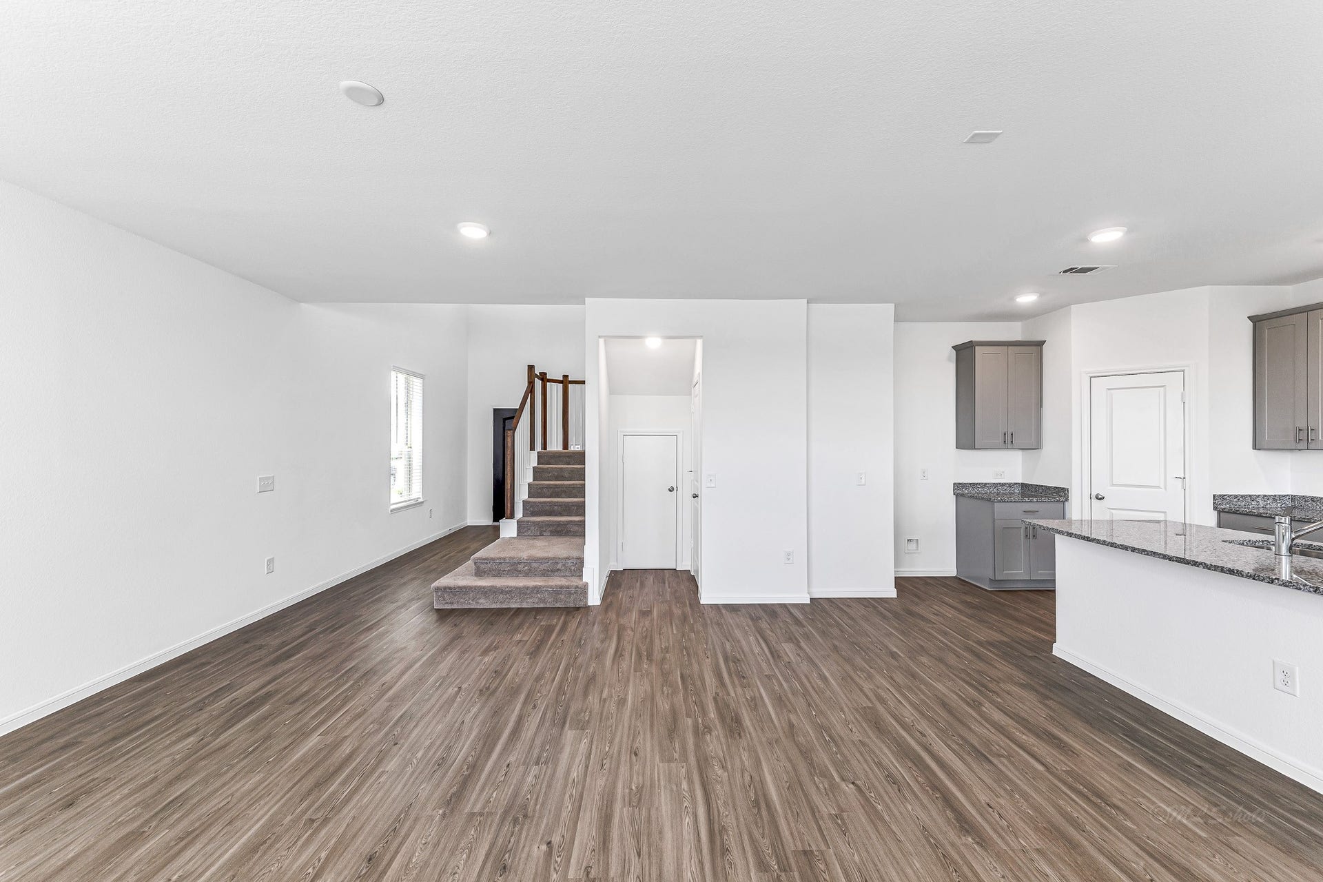 View from the family room to the staircase and entry foyer.