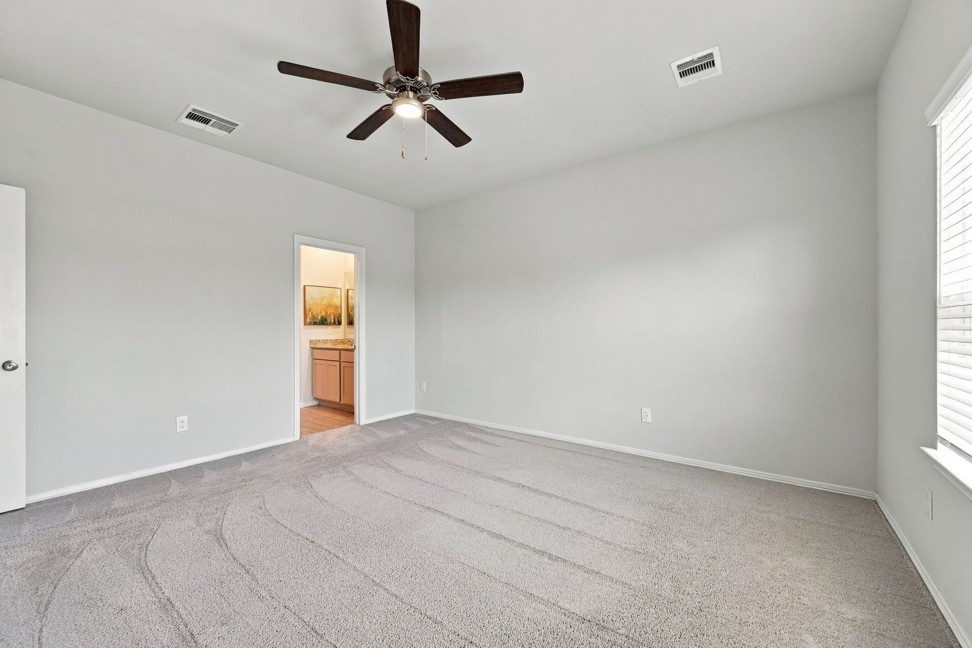 5702 Fresh View Court, Katy, TX 77493 Generous wall space provides flexibility for furniture arrangements, while the conveniently connected ensuite bathroom enhances the suite's private, thoughtfully designed layout.