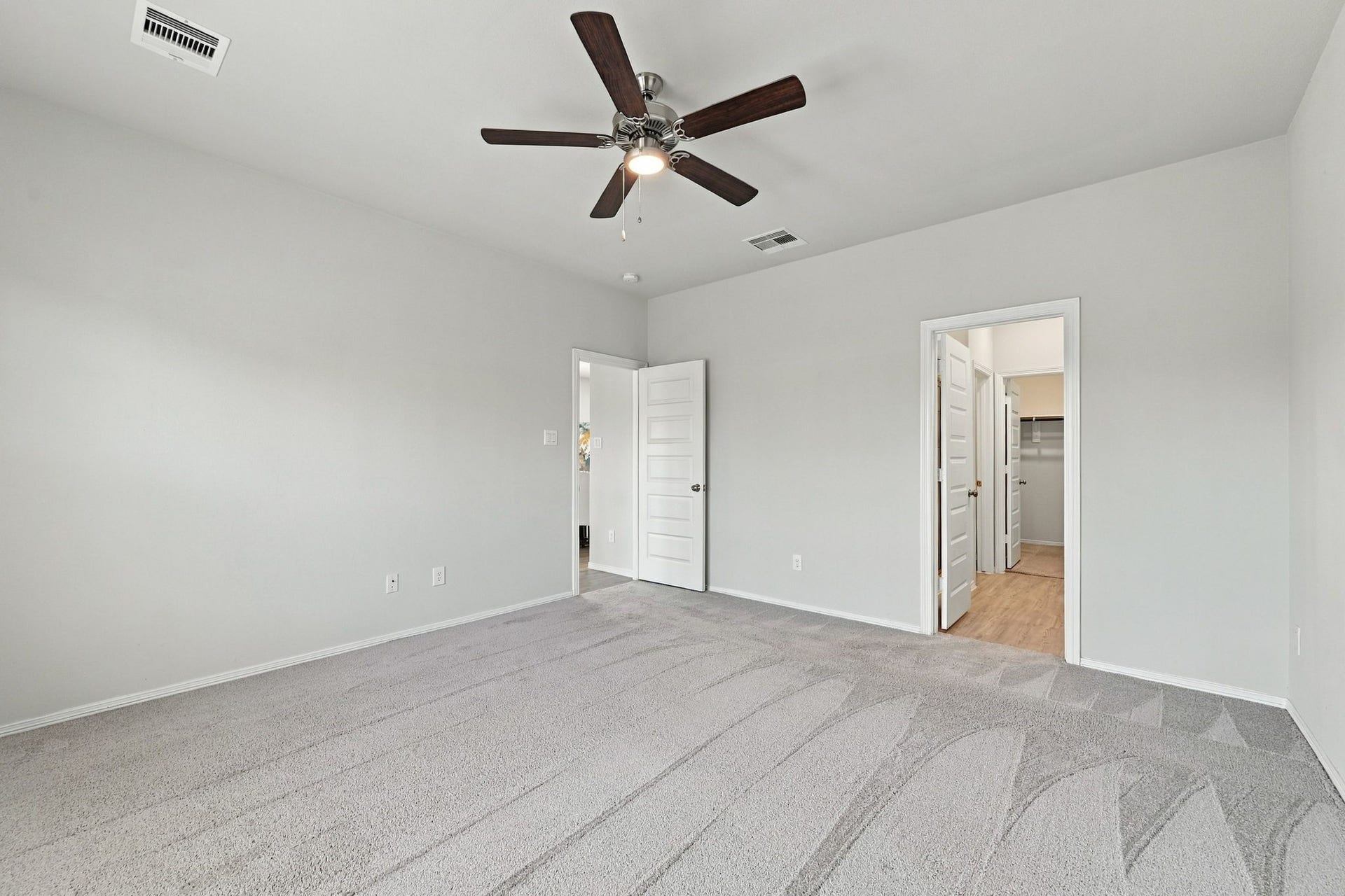 5702 Fresh View Court, Katy, TX 77493 The generously sized room provides ample space for a king-sized bed and additional furnishings. Just beyond, the private ensuite offers a spacious bath, separate water closet, and an oversized walk-in closet, bringing exceptional convenience to this inviting retreat.