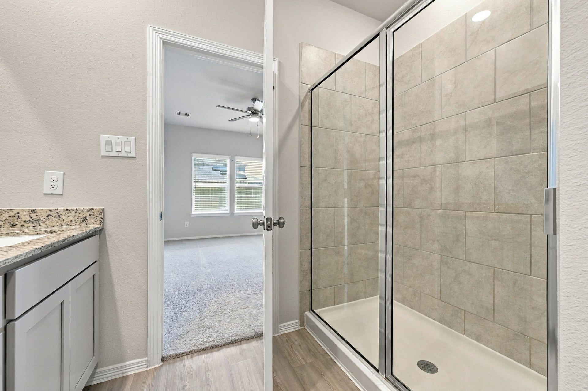 5702 Fresh View Court, Katy, TX 77493 Enjoy the comfort of an oversized walk-in shower featuring a frameless-style glass enclosure, beautiful neutral-toned tile surround, & sleek fixtures. Its spacious design complements the primary bathroom's refined finishes, creating an inviting space to begin or end your day.