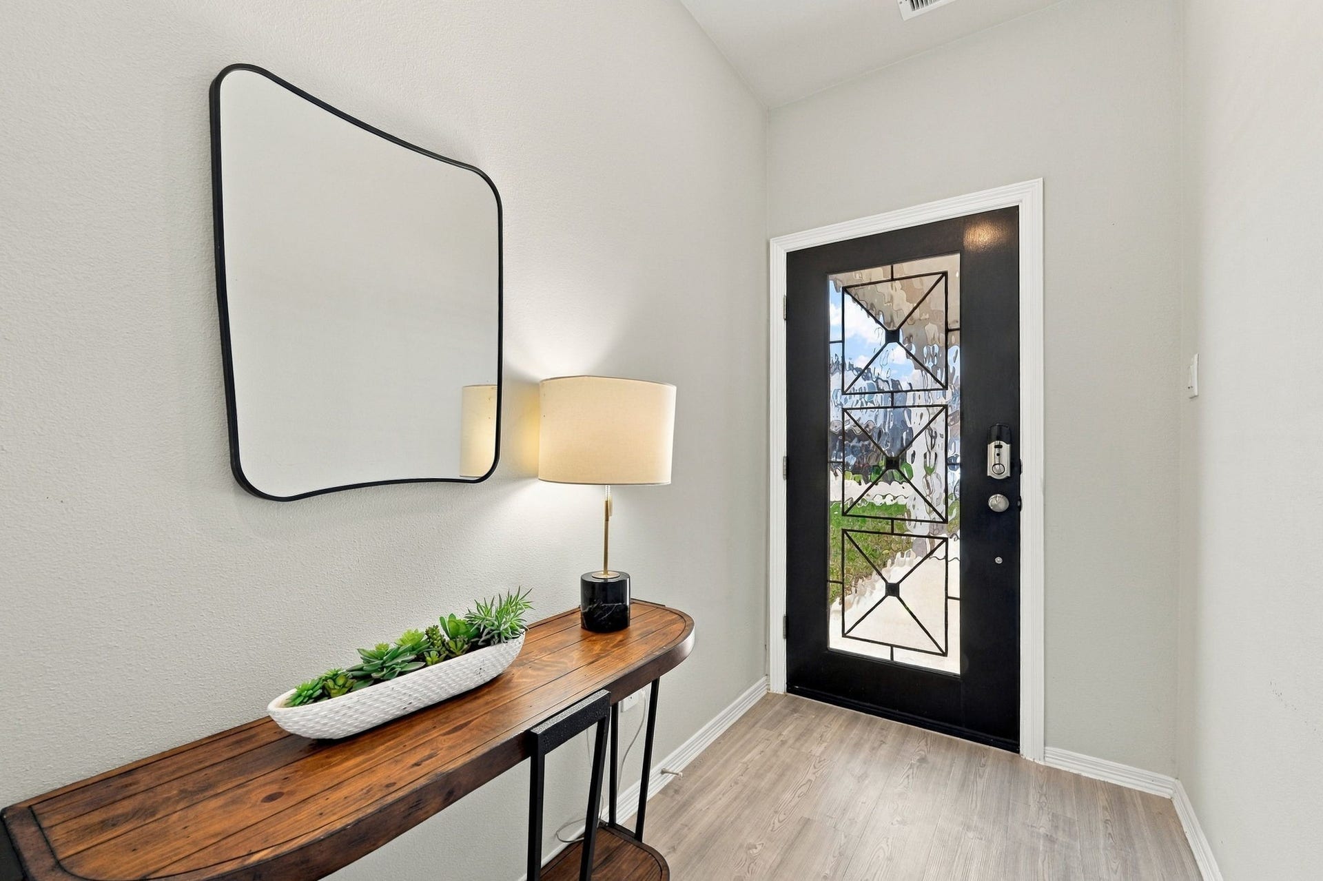 5702 Fresh View Court, Katy, TX 77493 The striking black front door with decorative glass detailing makes an elegant first impression, beautifully contrasting with crisp white trim & neutral walls.