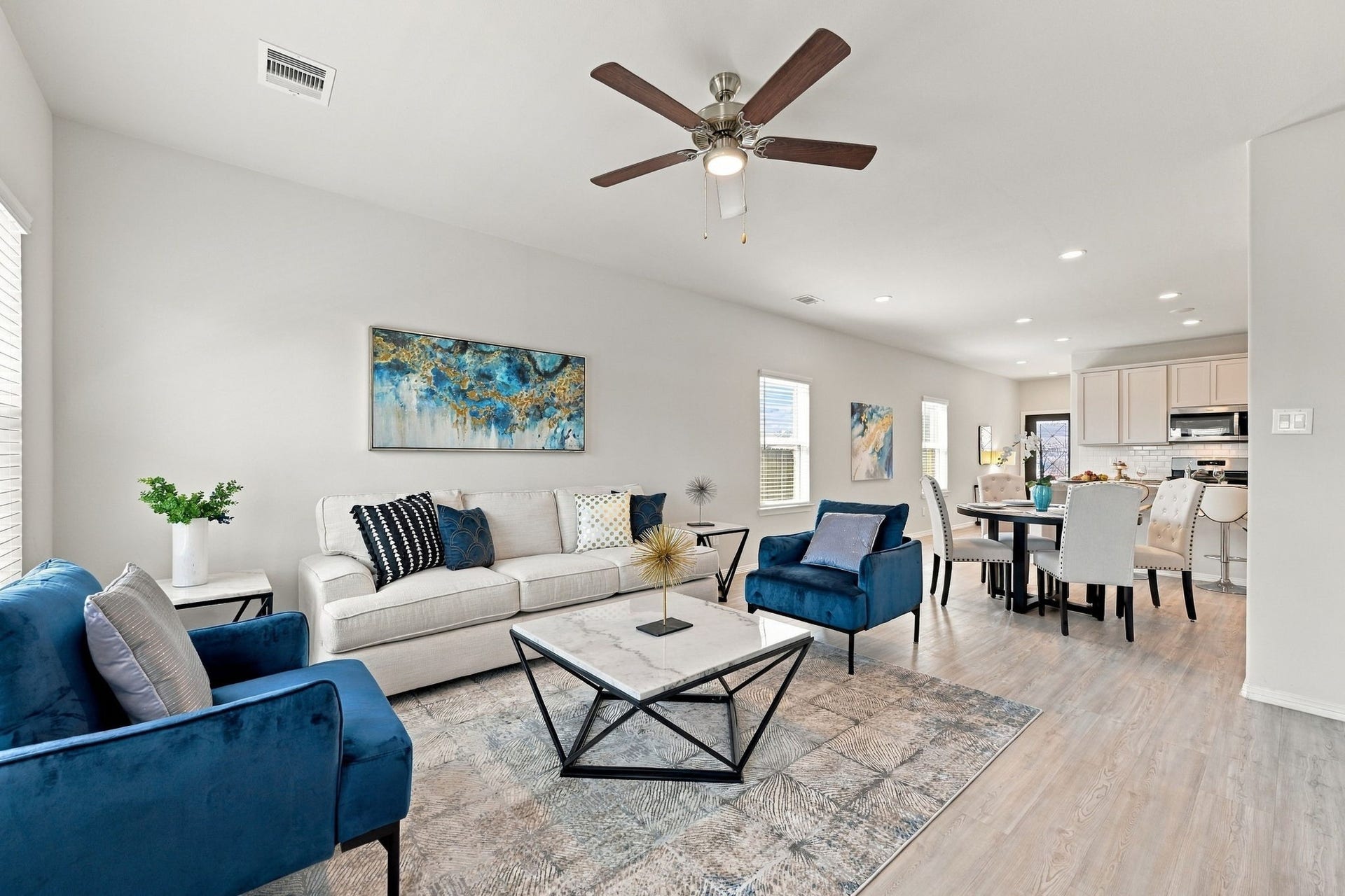5702 Fresh View Court, Katy, TX 77493 This perspective beautifully captures the home's effortless flow, with the family room opening directly to the dining area & kitchen beyond. The spacious arrangement allows everyone to stay connected, while high ceilings, recessed lighting, & coordinating finishes lend a refined touch to the entire living space.