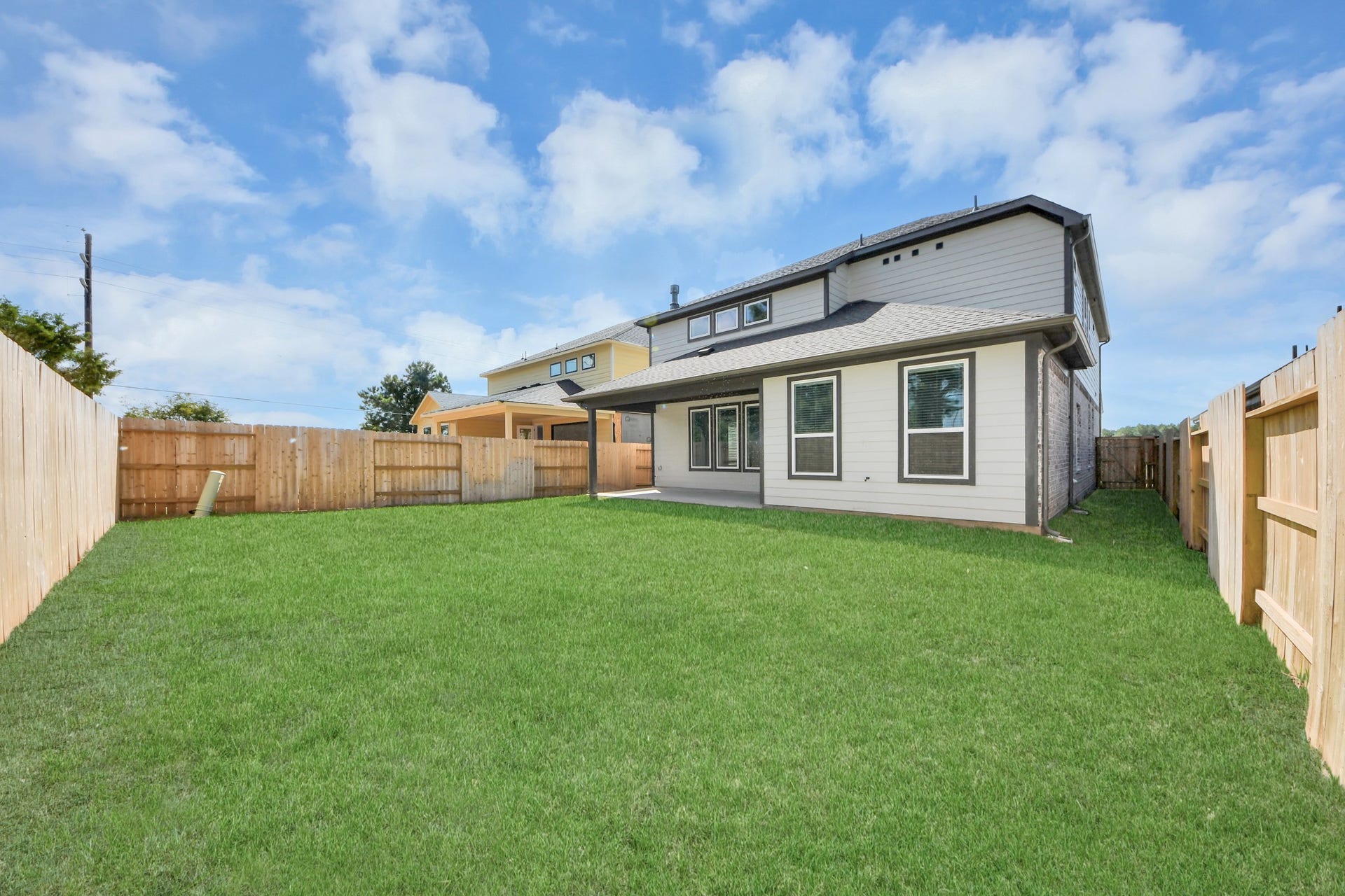 26395 Viva Drive, Magnolia, TX 77355 Backyard retreat, offering an abundance of space for kids to play and explore. The possibilities are endless in this outdoor haven, where the joy of open-air activities and family gatherings awaits.