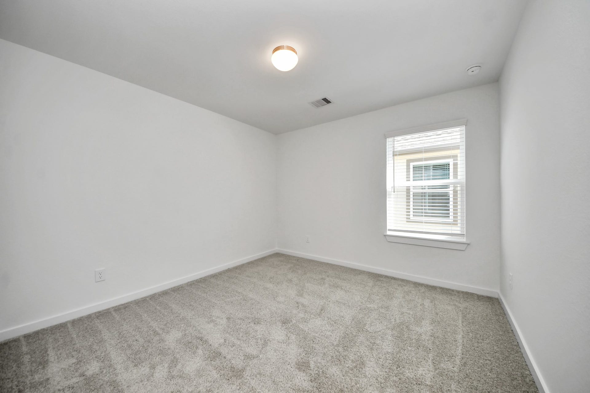26395 Viva Drive, Magnolia, TX 77355 Secondary bedroom features plush carpeting, large windows that let in plenty of natural light, bright paint, and spacious closets. Sample photo of completed home with similar floor plan. Actual colors and selections may vary.