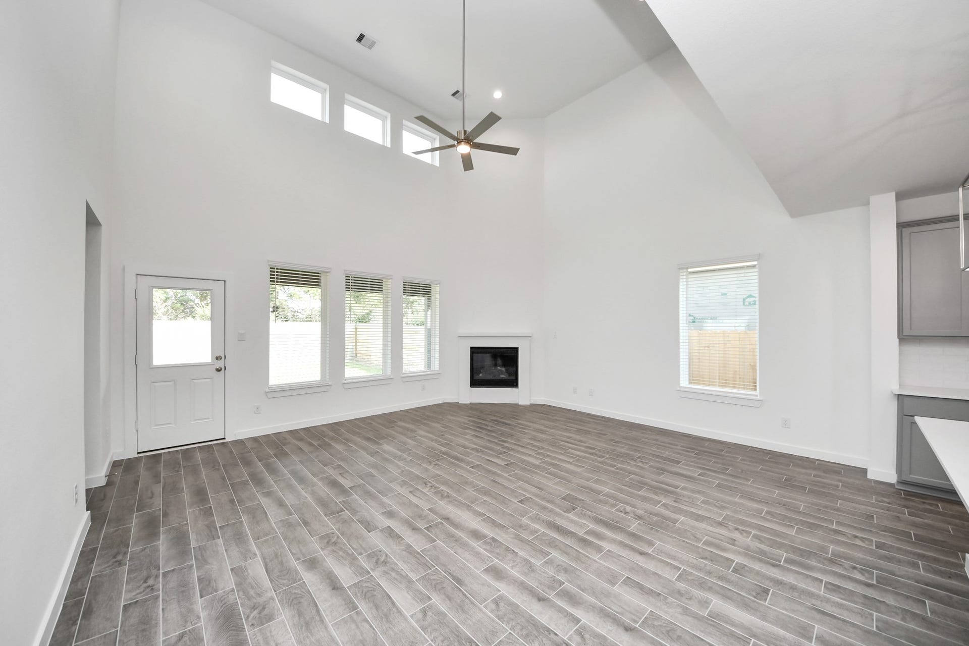 26395 Viva Drive, Magnolia, TX 77355 Gather the family and guests together in your lovely living room! Featuring soaring high ceilings, recessed lighting, ceiling fan, custom paint, gorgeous floors, and large windows that provide plenty of natural lighting throughout the day.