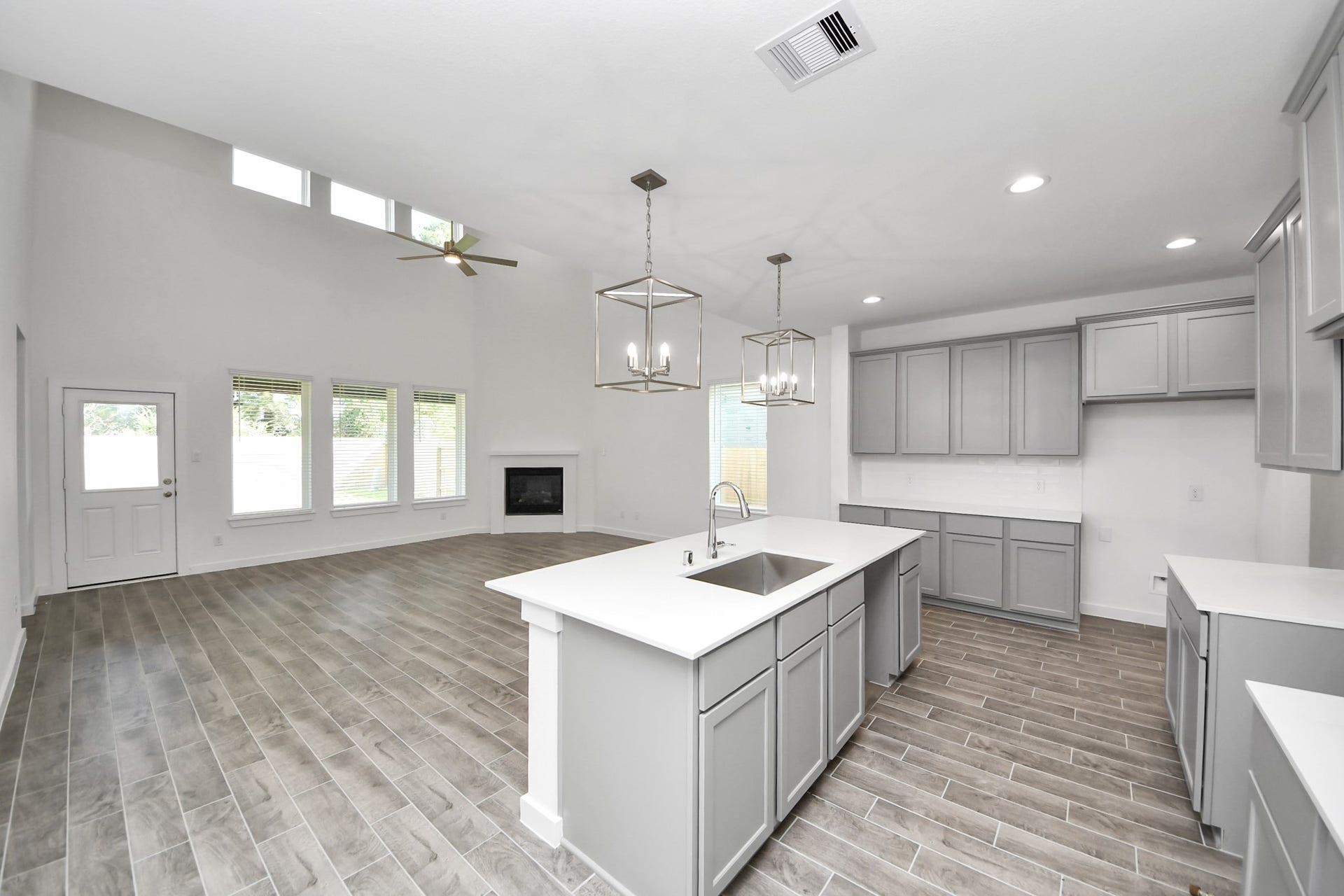 26395 Viva Drive, Magnolia, TX 77355 The open concept effortlessly connects the kitchen to the expansive family room, forming a perfect hub for gatherings. This seamless flow creates an inviting space where cooking and socializing come together harmoniously.
