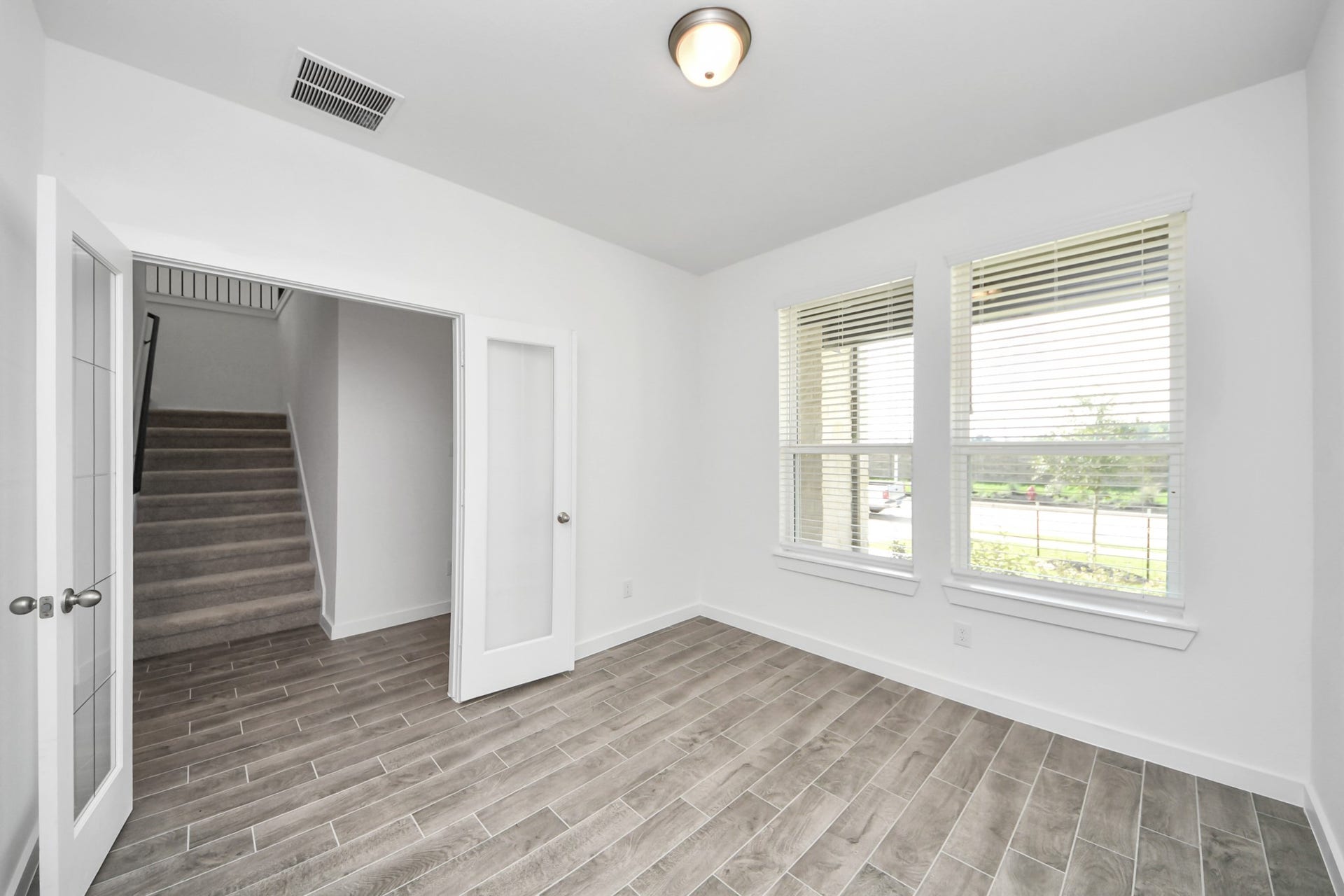 26395 Viva Drive, Magnolia, TX 77355 Step into the inviting home office, where elegant tile flooring adds a touch of freshness and comfort to the workspace. Natural light pours through the window, creating an inspiring environment for productivity and focus.