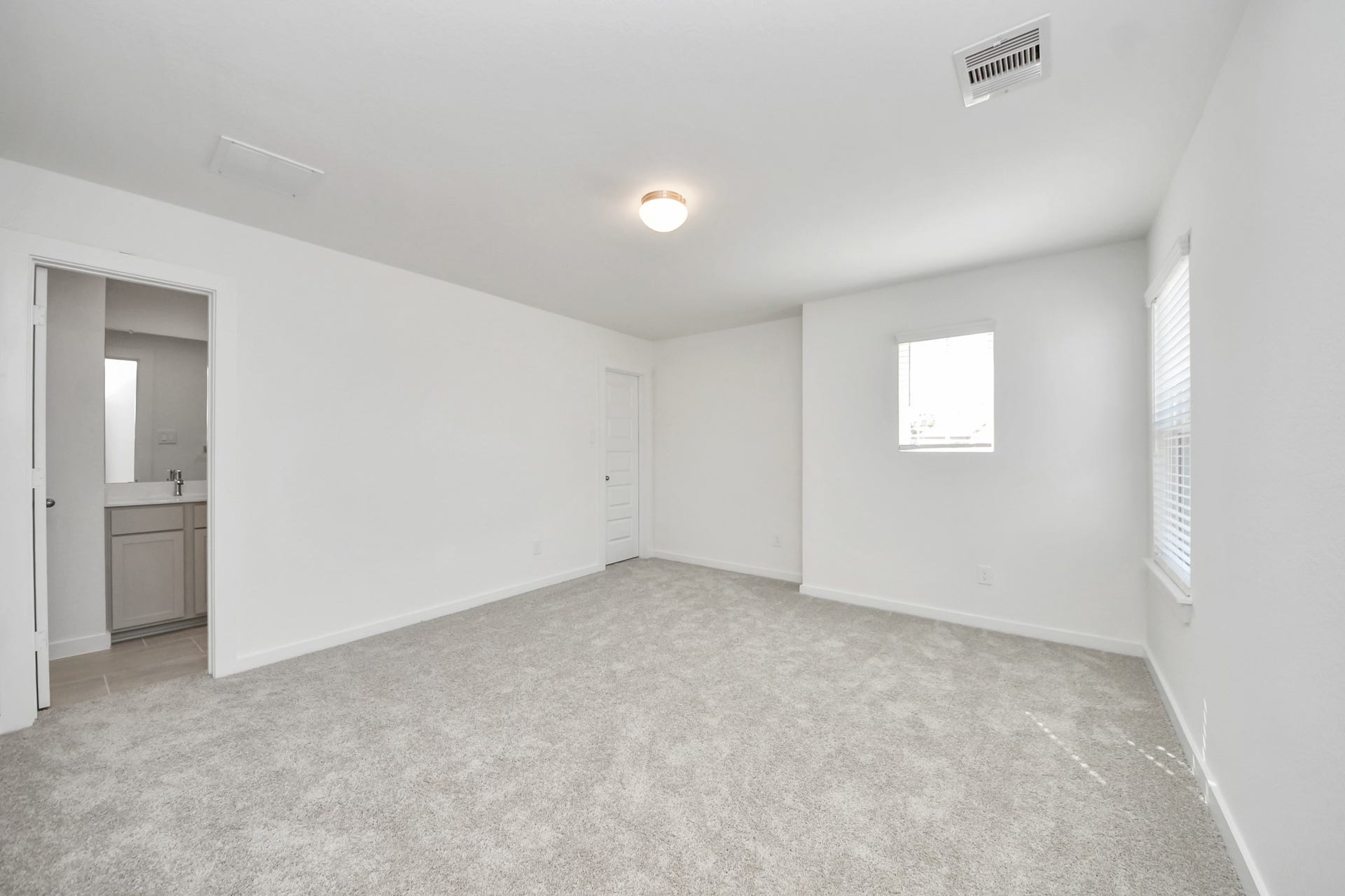 26395 Viva Drive, Magnolia, TX 77355 Secondary bedroom features plush carpeting, large windows that let in plenty of natural light, bright paint, and spacious closets. Sample photo of completed home with similar floor plan. Actual colors and selections may vary.