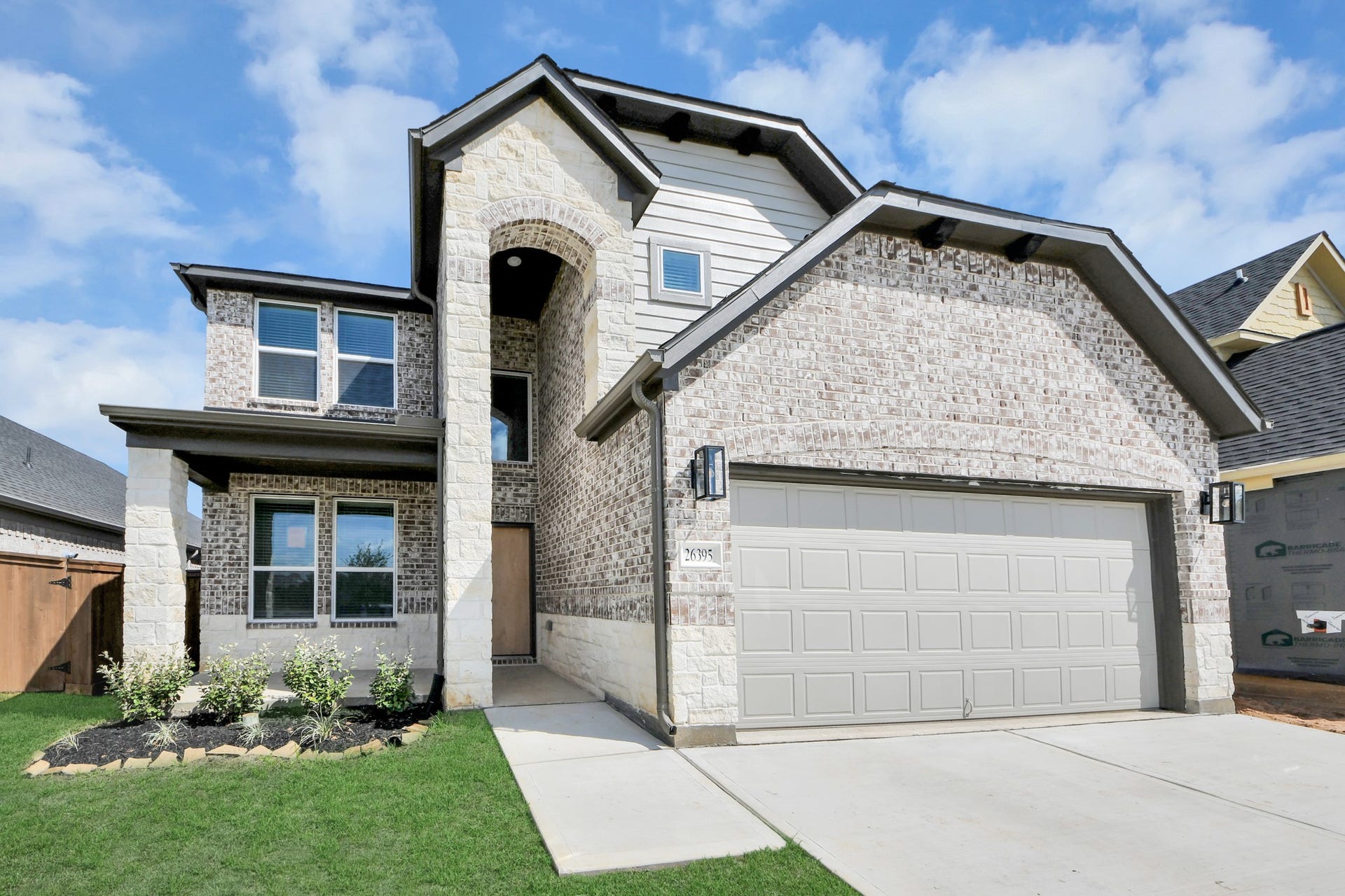 26395 Viva Drive, Magnolia, TX 77355 The residence features a practical 2-car garage complemented by a generous driveway, ensuring abundant space for parking needs.