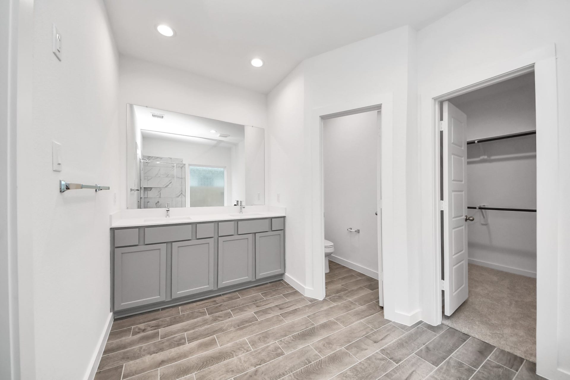 26395 Viva Drive, Magnolia, TX 77355 Elevate your daily routine at the elegant vanity, now equipped with double sinks, light countertops, modern hardware, and beautiful recessed lights.