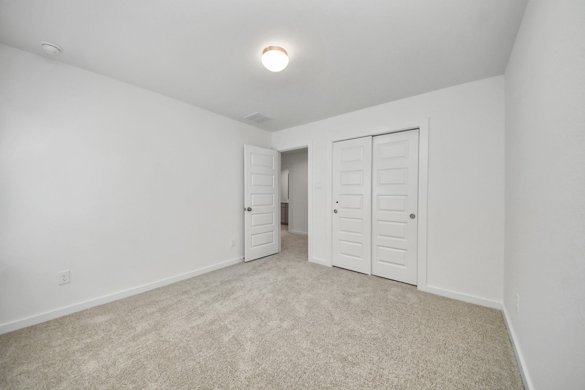 26395 Viva Drive, Magnolia, TX 77355 Generously sized secondary bedrooms featuring spacious closets, soft and inviting carpeting underfoot, large windows allowing plenty of natural light, and the added touch of privacy blinds for your personal retreat. Sample photo of completed home with similar floor plan. Actual colors and selections may vary.
