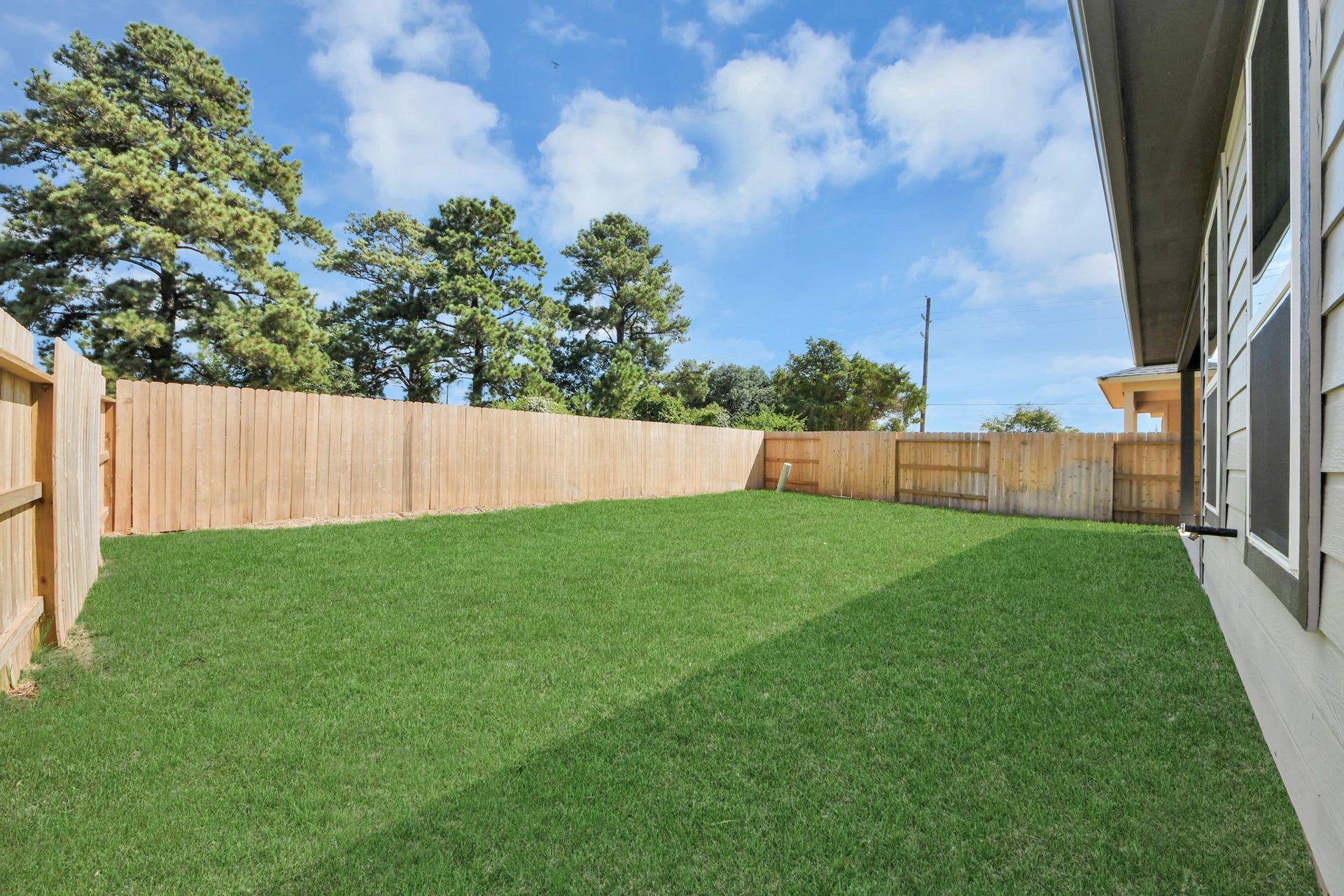 26395 Viva Drive, Magnolia, TX 77355 Discover the charm of this spacious backyard featuring a delightful covered patio. With ample room for both play and relaxation, it's the perfect outdoor haven. Tailor this space to your liking with patio furniture, a BBQ pit, and more. The potential for creating your dream outdoor living area is limitless!