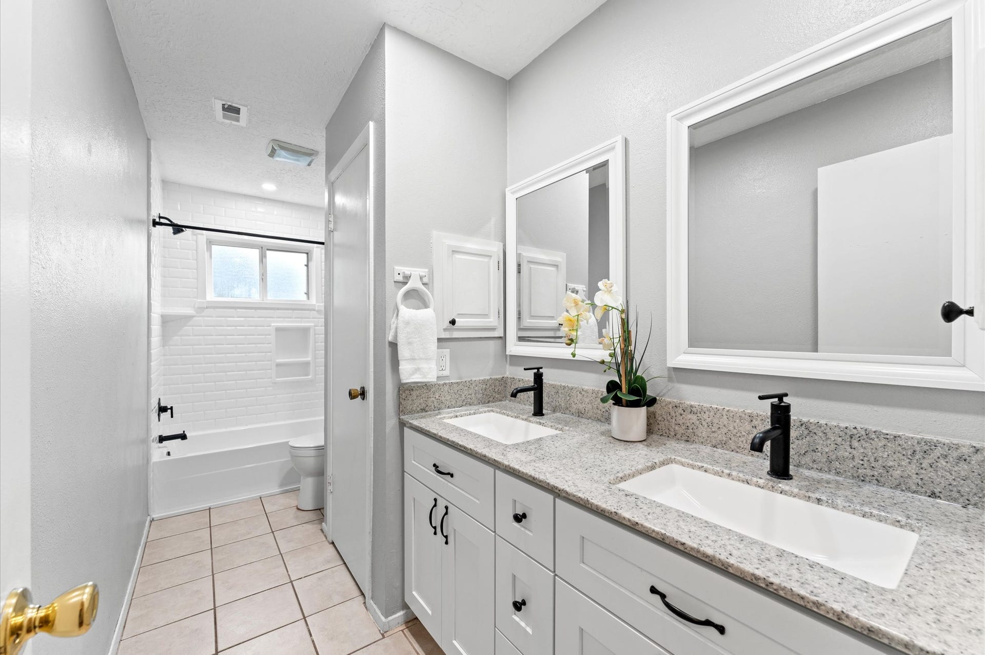 11227 Verlaine Drive, Houston, TX 77065 The hall bath was updated in 2023 to include granite counters, hardware, and framed mirrors.