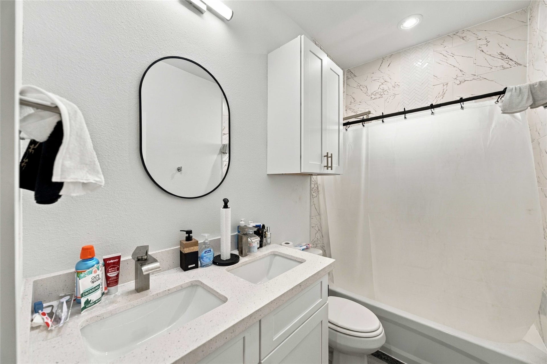 Double vanity, sleek finishes, and marble-look tilebecause sharing a bathroom doesn't mean sharing a sink.