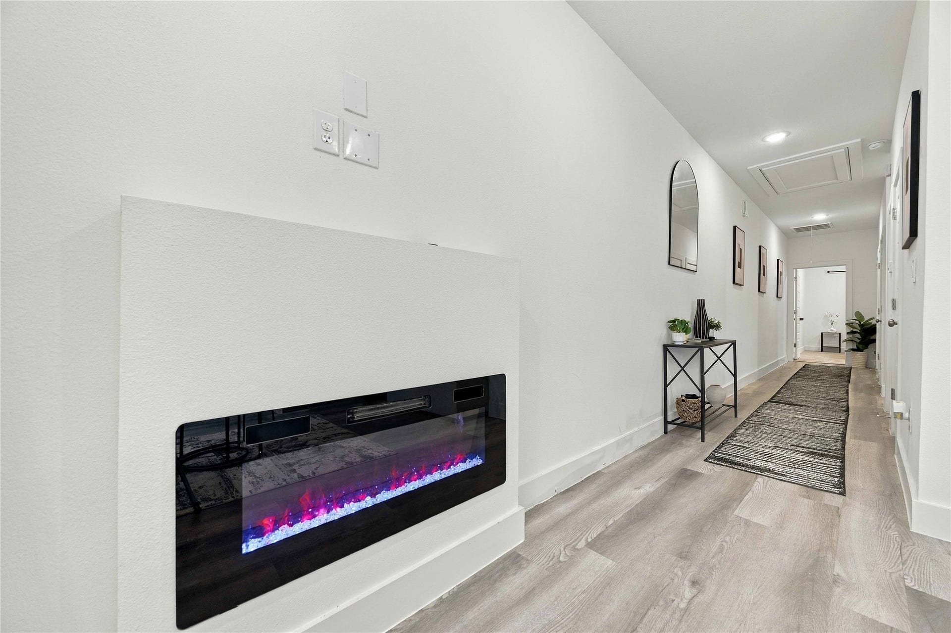 Who says hallways have to be boring? This one brings the drama with a sleek fireplace and modern finishes.